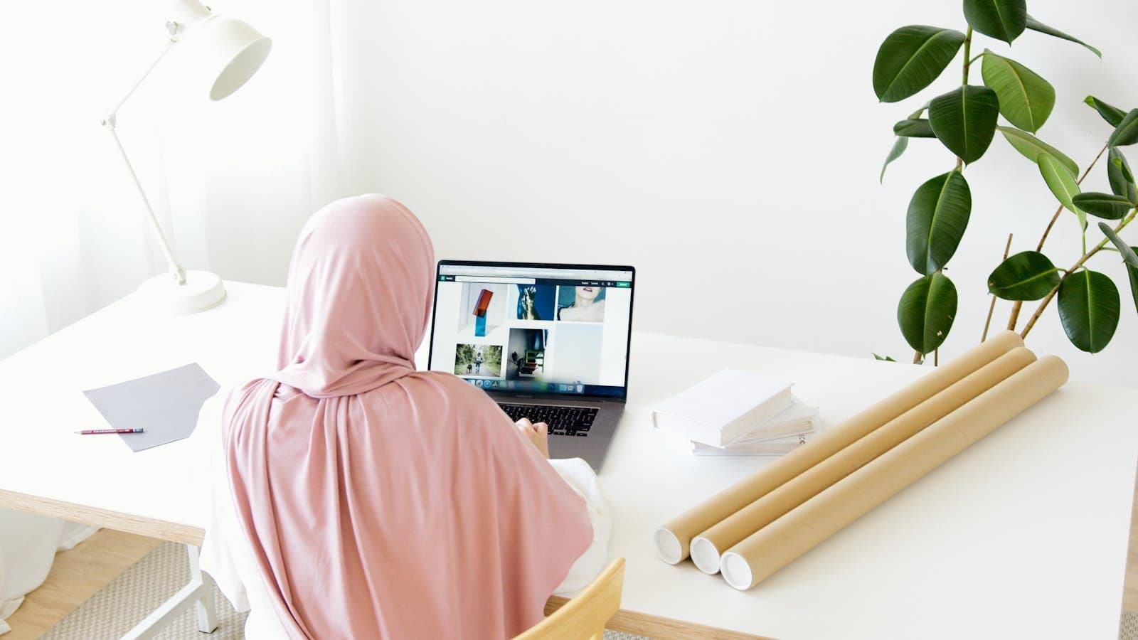 Young woman browsing designs on a laptop